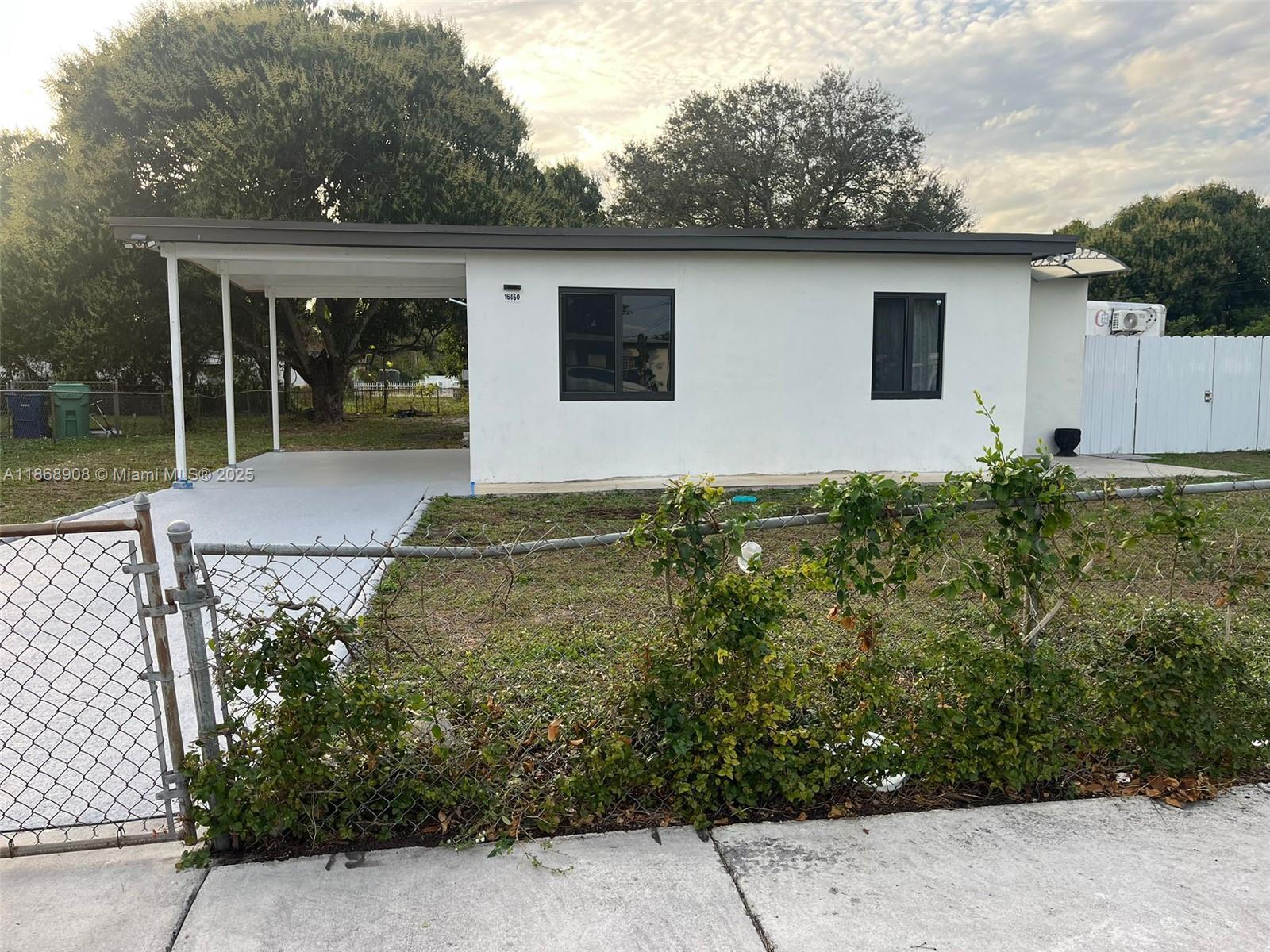 Beautiful single-family home in Miami Gardens available for annual rental. This 3-bedroom, 1-bath home offers 834 sq ft of living space on a large 9,000 sq ft lot with private fenced yard, carport, and covered patio. Freshly painted and ready to move in, with plenty of natural light and comfortable living areas. Convenient location close to schools, parks, shopping, and highways with easy access to Miami and Fort Lauderdale. Fast approval process. Separate RV on the side, fully fenced and not affecting privacy or yard. Lawn maintenance and water included in rent.