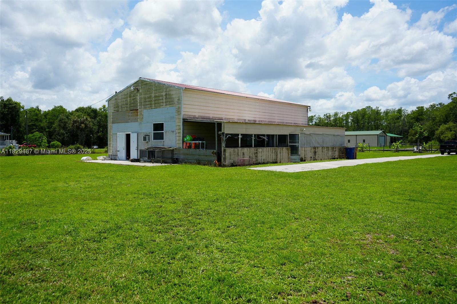 Barndominium on 4.96 acres 15 minutes from downtown Fort Myers! This unique property is comprised of cleared pasture, a pond, and a barn with living quarters. The structure is built on a concrete slab and is of metal construction. Featuring 2 large bays (garage doors have been removed), a loft, and a lean to shed on the side, this property would be perfect for anyone wanting to start their own farm or store vehicles/ equipment. The living quarters inside the barn is a studio style setup with a kitchen area and bathroom complete with a standup shower and spacious vanity. An additional bathroom space is located upstairs in the loft. In addition to the convenience this property offers, it also boasts privacy. Schedule your showing for this unique opportunity today!