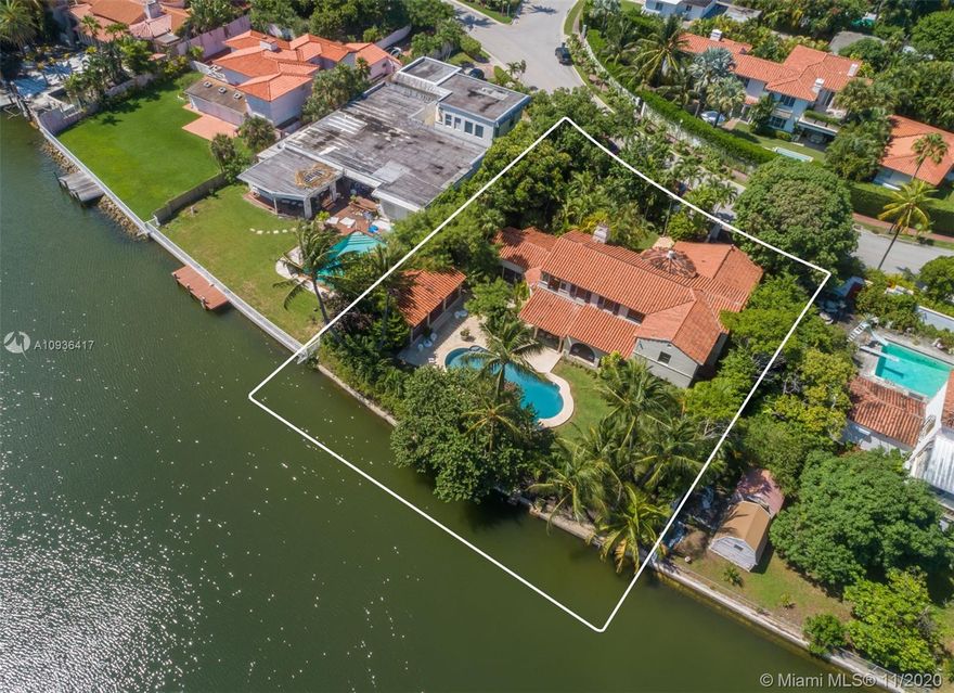 Rarely available! Glorious Italian villa situated on an oversized 17,645-SF lot with 100 ft of waterfront, ideal for those who love the grandeur of Mediterranean architecture. Its striking curb appeal and distinctive original details are unmistakable from every angle. A spectacular entry foyer with a rotunda staircase will lead you to the living areas marked with magnificent arched doorways, crown moldings, and terra-cotta floors. Large living room with intricate French clay coffered ceilings and a fireplace opens to a porch with a hand-painted Cuban tile where you can enjoy an oasis-like setting, overlooking the water and Faena House. The backyard is expansive with many sitting areas surrounding the pool, and a separate guesthouse with a kitchenette. The perfect restoration project!