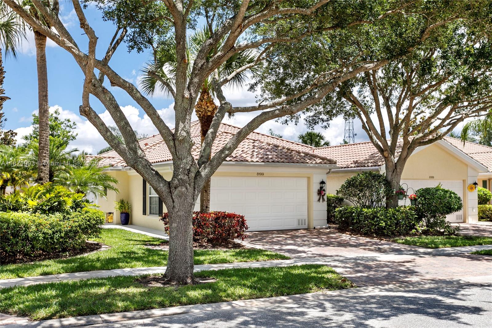 A supreme DiVosta built 2 BR 2 BTH Capri model villa primely located in the resort style community of Villagewalk. A sought after gated community offering 24 hour security, clubhouse, fitness center, pools, tennis, pickleball & many more amenities. Enjoy tree lined streets, 6 miles of trails, 93 acres of park, 112 acres of lakes & wildlife preserve. The Villa updates include: all new stainless steel kitchen appliances & kitchen sink faucet, attractive shiplap wall for TV with stained cedar shelving, porcelain/wood floors in BRs, renovated shower in primary bath, new washer/dryer & hot water heater, screened-in patio with new porcelain tile with built in summer kitchen, storage units in garage & extended attic doubling its storage space & hurricane panels.