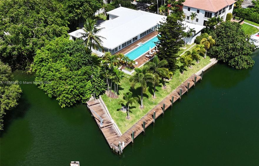 Welcome to 1261 S Alhambra Circle, located along the scenic Gables waterway. Situated on 22,000 sf of land, this property has water on two sides w/ 140’ of waterline complete with a 2013 renovated dock. Bridge clearance to the bay is 18’ making it ideal for all boaters. The rolling lawn & tropical wood pool deck are highlighted w/ a 75 ft. lap pool surrounded by the minimalist modern home, perched perfectly along the highest portion of the property. Featuring 5,256 total sf, the home boasts 6 beds, 6.5 baths w/ large entertaining space, a chef’s dream kitchen with Thermador appliances, primary suite w/ water views, walk-in closets & exquisite material finishes through all baths. Add’l features are office, laundry, maids qtrs, 2 car garage, motorized blinds, auto gates & security cameras.