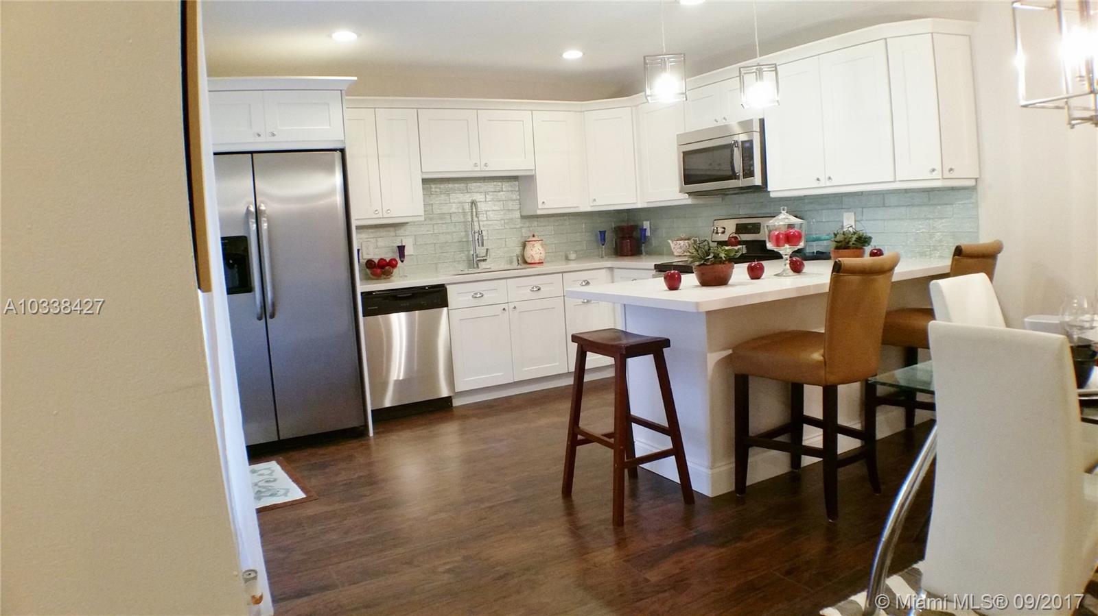 HOA 350/mo.Gorgeous, remodeled, updated unit, with beautiful new floors throughout. New kitchen with solid wood cabinets, Quartz counter tops, new appliances including top of the line washer/dryer. New AC. All 3 bathrooms have totally been remodeled w/ new floors, shower walls, vanities, mirrors, lights. New custom made banisters that give this unit a totally elegant look. You won't be disappointed. A unique model with a screened, covered porch with new skylights for additional living area. This is a must see. The fine work & craftsmanship for the most particular buyer. Located in a manned gated , 55+, pet friendly community. Active clubhouse & all it's amenities, theater, tennis center, gym. Best of all, close to downtown Delray Beach where all the action is and the beach.
