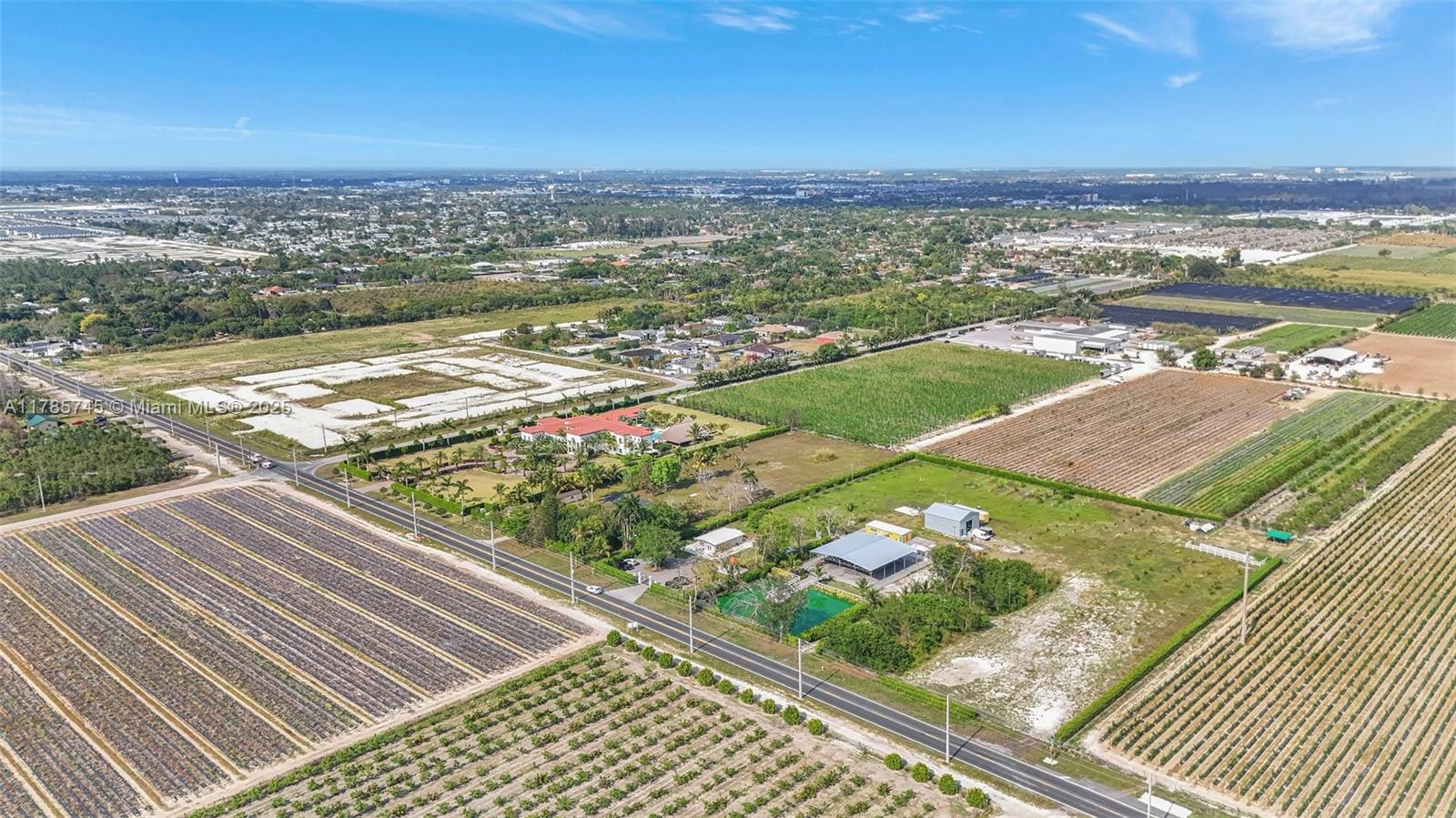 Huge 5.15 acres lot ( 224,449sq-ft) perfect for an investor or end user. Private and fully fenced. It features a cozy 2 bed / 2 bath home completely remodeled with modern finishes, impact windows, spacious open kitchen and lots of natural light. Separate guest house with 3 half baths and an additional storage room. Lot also features a 70x70 pole barn, a 36x40 storage steel building and a beautiful pond filled with fish. Income producing fruit trees already planted and with a permit. Great location with lots of growth and new developments around. This gem is a must see.