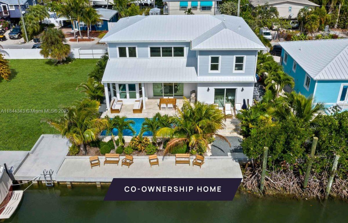 New co-ownership opportunity - Own 1/8th of this professionally managed, turnkey home by Pacaso. Tucked within the coveted White Marlin Beach enclave, this canal-front retreat captures the essence of refined Florida Keys living. The 5-bedroom, 3.5-bathroom residence offers a seamless blend of comfort and coastal elegance. The open-concept main level is bathed in natural light, with soaring ceilings, oversized windows, and glass doors that connect the living area to the private pool and tranquil canal beyond. The main-floor primary suite features a custom walk-in closet and direct access to the patio and pool. Upstairs, a second spacious bedroom offers a large closet and a Jack-and-Jill bath shared with an adjoining guest room. The home comes fully furnished and professionally decorated.
