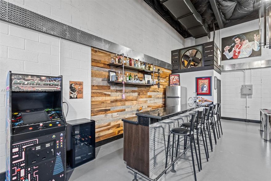 Turnkey and fully furnished, this converted warehouse offers a one-of-a-kind private space with endless creative possibilities. Featuring insulated 18–20' ceilings with custom chandeliers, LED lighting, a stereo system, and full air conditioning, this property blends industrial scale with luxury finishes. The kitchenette boasts granite countertops, a bar setup, and seating areas. Enjoy two lounge zones, a pool table, and a classic Pac-Man game. Perfect for private events, podcast studios, artist storage, or creative work—not for industrial or active business use. Located in a secure, gated community with no industrial activity, offering privacy, exclusivity, and style in one package. All information is believed to be accurate but is not warranted. Buyers to conduct their own due diligence.