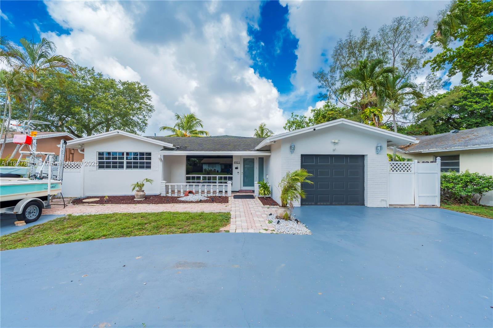Spacious 4-bedroom and 2-bathroom home with gorgeous pool and fully fenced in yard. Home offers an amazing open floor plan & split bedrooms ideal for comfortable living and entertaining! Features include a large kitchen with stainless steel appliances, tile flooring throughout, and fresh exterior paint. Enjoy the oversized pool, private fenced backyard, and charming gazebo—perfect for gatherings. Includes a 2-car garage, huge circular driveway, several hurricane-impact windows, and sliding doors. Additional highlights: Roof (2013), A/C (2018), Water Heater (2021). Immaculately clean and move-in ready! Located on a quiet street leading to a park and just 1.5 miles from FLL Airport, Dania Pointe, beaches, Hard Rock Hotel & Stadium—with no HOA!
