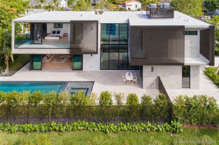 New modern luxury home on the Venetian Islands of Miami Beach. Completed in 2018 & designed By Ruben Gomez of AI2 Design, this masterpiece has the ultimate mix of sharp & dramatic contemporary appeal with warm tones & finishes to create the ideal harmonious atmosphere. Featuring lighting designed by Porche Design Studio By Apure, a large living room overlooking the pool, a formal dining next to an interior garden, a high-end kitchen with Ital-Kraft cabinets, a cooking island, & SubZero/Wolf appliances. Wall-to-wall sliding doors open-up completely to create the ideal indoor/outdoor entertaining experience. Upstairs, four bedrooms with en-suit baths & large closets, including a master with a big terrace, walk-in closet, & luxe bath. Outside, a heated pool with built-in spa.