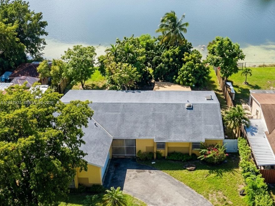 RARE VALUE OPPORTUNITY IN COUNTRY LAKE MANOR! Discover exceptional value in this spacious 3-bedroom, 2-bathroom single-story home situated on an impressive 9,750 square foot lot. This 1,514-square-foot concrete block home, built in 1985 with solid construction and excellent bones, sits on one of the larger lots in the community and offers tremendous expansion potential, with room for a pool, outdoor entertaining areas, or playground space. The property features a generous 636 square foot covered patio perfect for Florida outdoor living, wood fencing for privacy, and all the foundational elements of a wonderful family home in an established neighborhood with A-rated schools nearby and convenient access to Miami Lakes Town Center, shopping, dining, and major highways, including the Palmetto Expressway. **PHOTOS ARE VIRTUALLY STAGED** - Images show design potential with AI-generated furniture, finishes, and renovations. Property is sold AS-IS in its current, original 1985 condition, requiring full cosmetic renovation