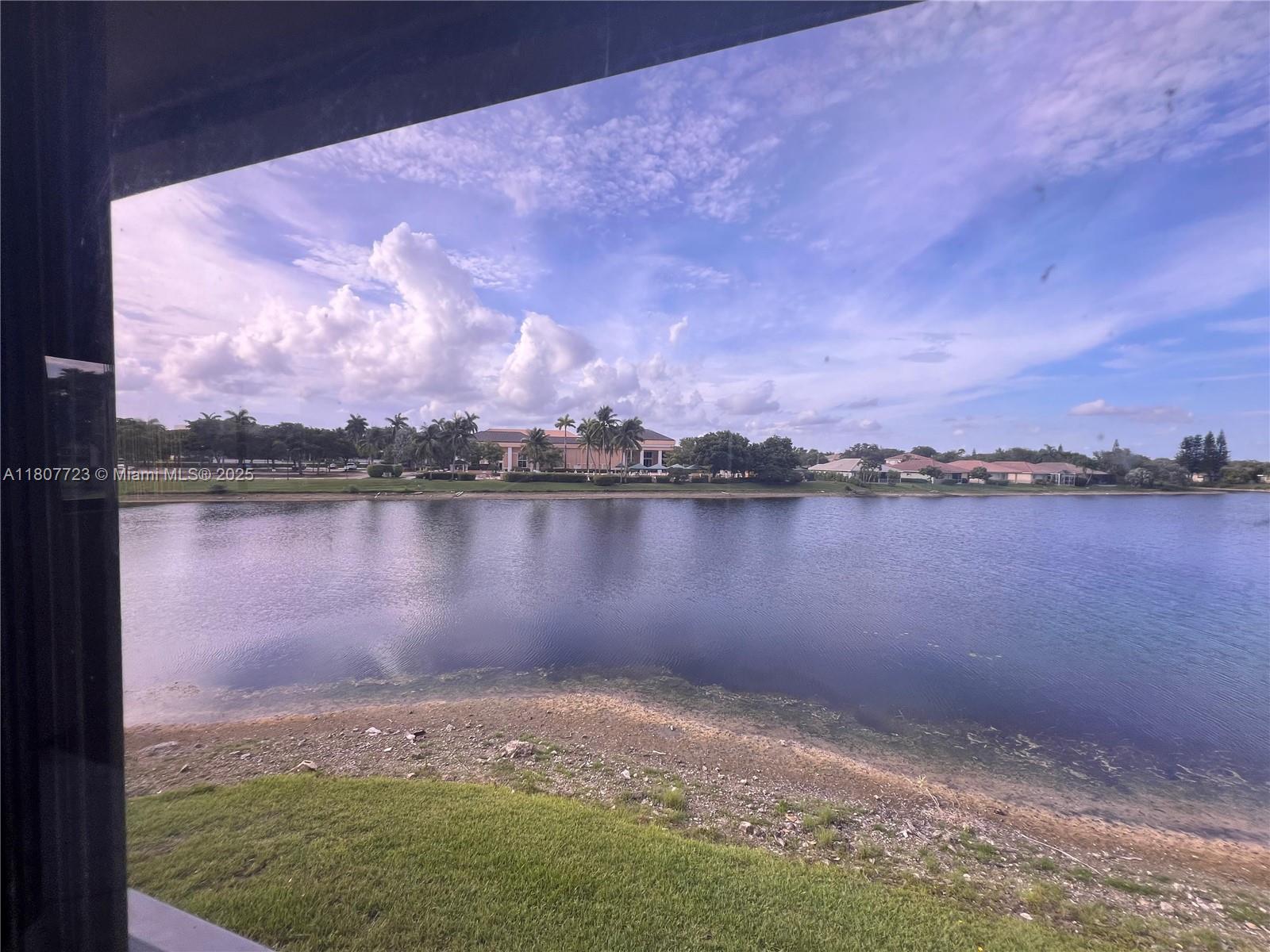 BEAUTIFUL CORNER UNIT, WIDE LAKE-VIEW FROM LIVING AREAS AND BEDROOMS, 2 BEDROOMS, 2 BATHROOMS AND A LARGE DEN THAT CAN BE CONVERTED INTO A 3RD BEDROOM OR AN OFFICE, TILE FLOOR IN LIVING AREAS, LAMINATED WOOD IN BEDROOMS, WALKING CLOSETS, UPDATED KITCHEN WITH GRANITE COUNTERTOP, WOOD CABINETS AND WHITE APPLIANCES, WASHER AND DRYER IN THE UNIT, HURRICANE SHUTTERS, LARGE SCREENED PORCH WITH LAKE AND CLUB HOUSE VIEWS, ASK FOR THE OPTION OF HAVING ELEVATOR SERVICE, THIS 55+ COMMUNITY HAS OUTSTANDING CLUB HOUSE AMENITIES THAT INCLUDES AMAZING THEATER, HEATED INDOOR AND OUTDOOR POOLS, CRAFT ROOMS, TENNIS COURTS, BUS SERVICE AND MORE, CLOSE PROXIMITY TO SAWGRASS EXPRESSWAY, SHOPPING CENTERS, RESTAURANTS, HOSPITAL