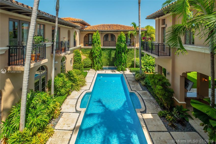 Rare offering of an exquisite custom estate set on a corner 20,500 sq.ft lot with 10 foot elevation and tucked behind mature hedges. Sprawling 7,698 sq.ft. (per plans) of living areas set among carefully conceived garden rooms with tropical landscape views from every window. Formal entrance leads to 12 ft ceilings with detailed moldings. This 7 bed and 8 ½ bath residence has thoughtfully designed living spaces. Expansive windows flood home with natural light. Features include private gardens, pool,separate 2 bed guest house, chef's kitchen with butler pantry & wine room cooled to exact temperature. Staff quarters with bath next to laundry room. Home’s occupants will enjoy 2 family rooms, one up one down, pool spa, 3 car garage, covered patio with built in grill and wet bar. Sheer elegance!