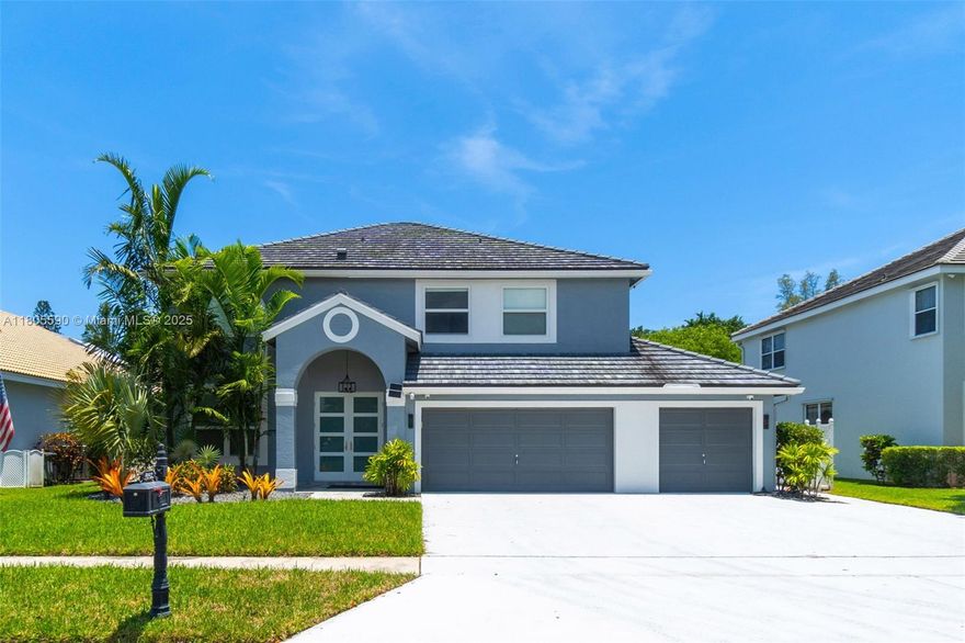 An extraordinary estate in the coveted Le Palais enclave of Rainbow Lakes: A stately five-bedroom, 3½-bath residence with a three-car garage. At its heart, a gourmet kitchen boasts a nine-foot center island, custom cabinetry, and premium appliances, flowing into living areas accented by oversized 16"×48" porcelain tile, bespoke Lutron window shades & LED lights. Luxuriously updated bathrooms feature designer fixtures & refined tilework, while a private theater—with tiered seating and state-of-the-art AV—elevates movie nights. Additional enhancements include Marvin hurricane-rated windows & doors, and a flat roof treated with clear-seal, high-performance coating (2021). Whether entertaining guests or enjoying quiet family moments, this home harmonizes sophistication & comfort at every turn.