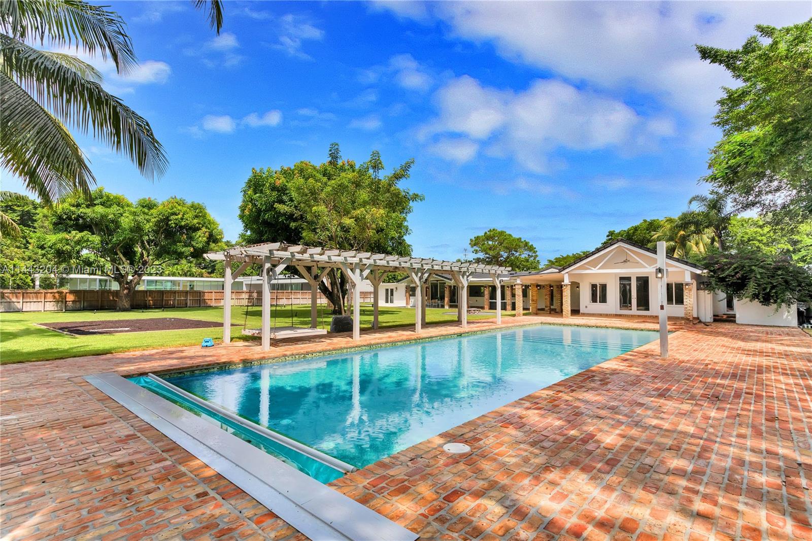 Discover modern luxury at 7800 SW 115th St in prestigious Pinecrest, FL. This extensively updated home boasts 5 bedrooms, each with its own ensuite bathroom, providing unparalleled comfort & privacy. Spanning 5,141 adj SF, the residence offers large living spaces that merge elegance with function. A chef's kitchen is adorned with top-of-the-line appliances and custom Wenge wood cabinetry. The connected living, dining & family rooms overlook a large covered patio through enormous impact windows & doors. With a sprawling 39,204 SF lot enveloped by large lawn and fruit trees, the outdoor space is a private oasis, the inviting pool is surrounded by a landscape that offers a serene backdrop. Embrace the serenity of this prime location while enjoying convenient access to urban amenities.