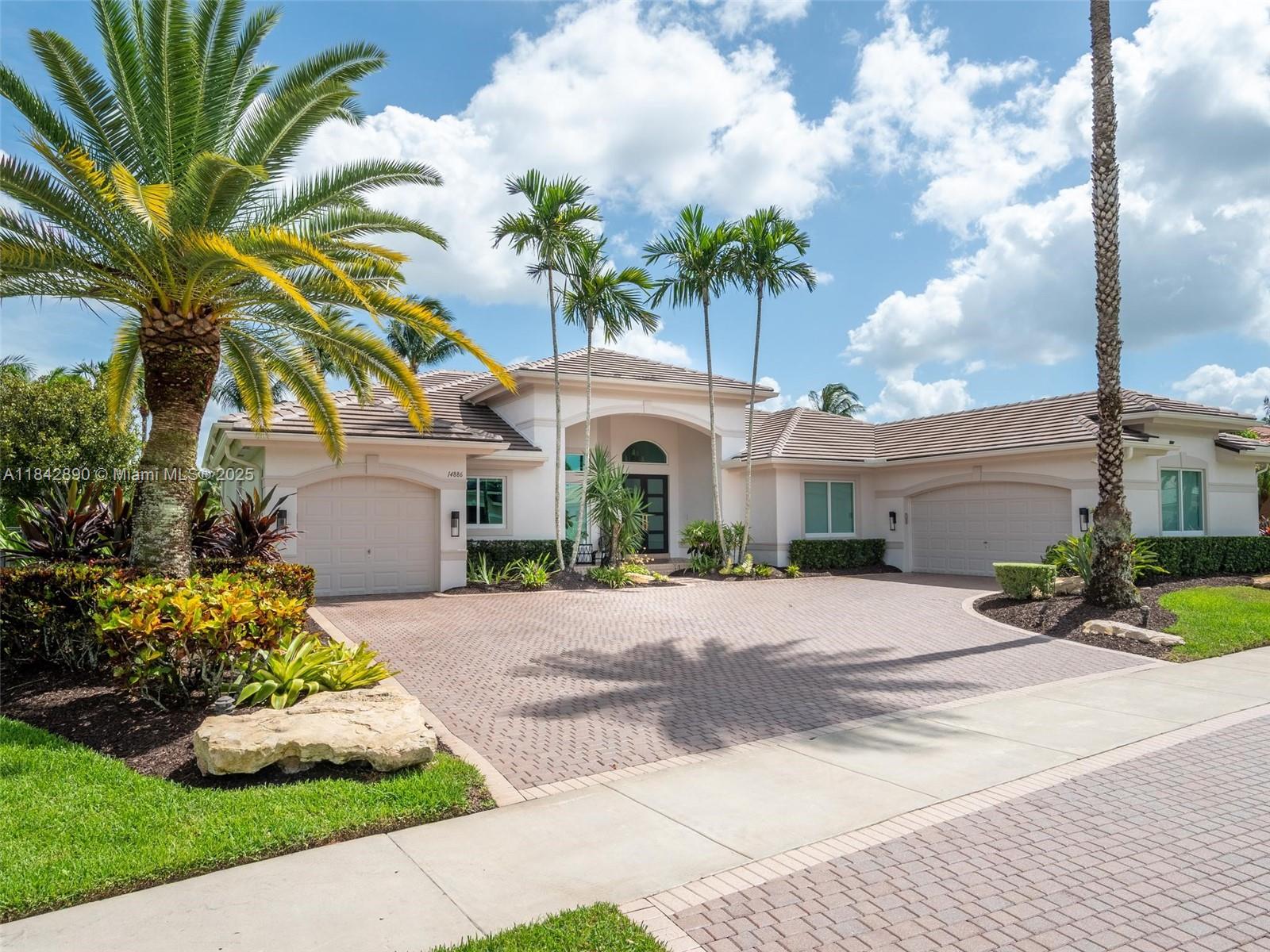 Welcome to the epitome of modern living in the gated Riverstone community. This expansive 4,635sf lakefront home features 6 bedrooms & 4.5 bathrooms. This completely updated home offers an open triple-split floor plan with 14-foot ceilings, complemented by a gourmet kitchen with premium stainless steel appliances. The master suite, with separate his and hers bathrooms, enhances luxury and comfort. Step outside to a private backyard oasis featuring an oversized heated pool/spa, perfect for relaxing and entertaining. Additional highlights include a new roof (2023), impact glass windows/doors (2021), and new AC's (2021). With a three-car garage and a generous 36,946-square-foot lot, this property perfectly blends style and functionality in a serene South Florida setting.