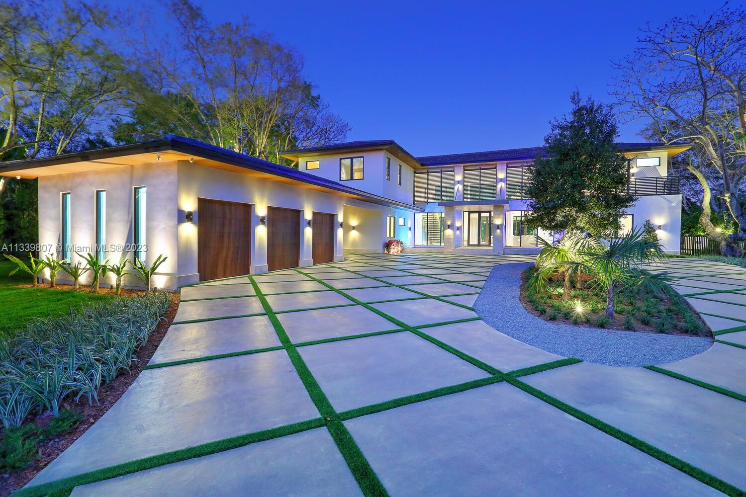 This gated North Pinecrest estate sits on a 50,529 sqft lot & has a total of 12,124 sqft, w/ 8 bedrooms, 9.5 bathrooms, theatre, gym, office, 3-car garage & a double carport. You are welcomed by the grand entrance surrounded w/ beautiful coral rock & double water display. The home features a mix of modern & traditional design elements, w/ an emphasis on sophistication & elegance. The home features Peruvian teak wood throughout the high ceilings, which adds warmth & character to the space. The Italkraft kitchen is equipped w/ Fisher & Paykel & Wolf appliances. All bedroom closets & bath vanities done by Miacuccina.The outdoor spaces include a pool, gazebo & summer kitchen, surrounded by a tropical setting. Includes: gas generator, wine display, Creston automation system & 2nd family room.