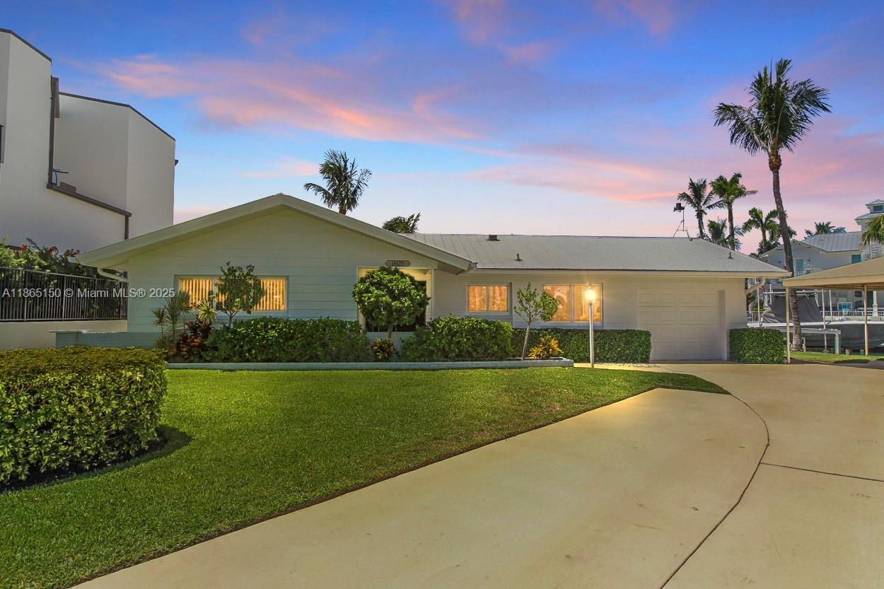 Rare Opportunity for this prime waterfront location minutes to the Jupiter Inlet with no fixed bridges! Situated on .35 acre corner lot with 123 ft plus of seawall this 3 bedroom / 2 bath pool home has endless possibilities. Dock includes one 50 ft dock with composite decking 60 amp pedestal and a 15 ft dock with a 16k boat lift- all new electric dock wiring in 2025. Updated Kitchen with granite countertops and stainless steel appliances , Hurricane Impact windows and doors. Pool resurfaced in 2025 with new equipment & heater. Truly a one of a kind oppurtinuty to own on the Jupiter Waterway !