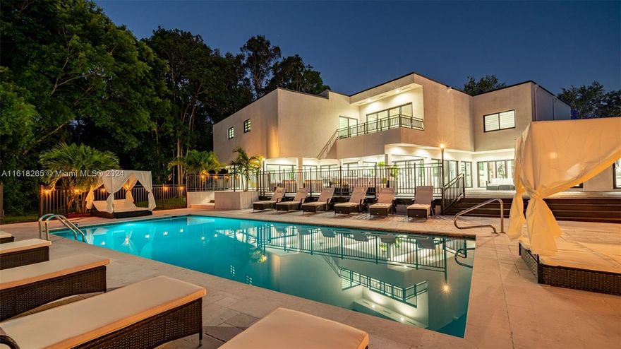 Experience contemporary elegance in this 9-bedroom, 6-bath home spanning 8,582 sq ft (10,819 sq ft total). Featuring vaulted ceilings and modern upgrades throughout, including a chef’s kitchen with Jenn Air appliances, quartz counters, and porcelain tile in living areas. Wood floors grace all bedrooms, with a first-level en suite overlooking the patio and heated pool.

The master suite boasts a tray ceiling, soaking tub, and dual-person shower. Ample parking with a large driveway offers convenience and privacy in the exclusive Plantation Acres community, minutes from the airport, shopping, and top schools.
 This massive property includes ample parking with a huge driveway, ensuring convenience and privacy.