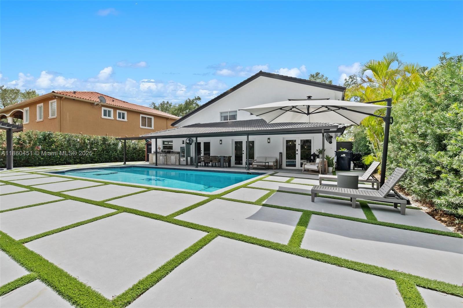 Discover this tastefully remodeled 5 bedroom residence in the prestigious Royal Oaks community of Miami Lakes, An extended driveway leads to a modern entrance, welcoming you into a home where contemporary style meets comfort. Enjoy a beautifully updated kitchen boasting sleek countertops, state-of-the-art appliances, and ample cabinetry perfect for culinary enthusiasts and entertaining alike. Master bathroom has been redesigned into a spa-like retreat with elegant finishes. The outdoor patio area has also been transformed, providing an ideal setting for relaxation and gatherings. Located near top-rated schools, shopping, dining, and major highways, this home blends modern luxury with everyday convenience. Experience the perfect blend of modern luxury & convenience in this remarkable home.