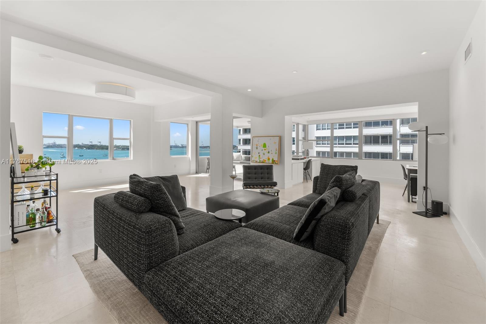 Modern 7th-floor unit with 9 ft ceilings offering light, bright, and spacious living with sweeping bay views from all rooms. Updated condo with modern finishes, two large ensuite bedrooms featuring marble baths, and generous closet space. Includes a versatile office/den area for added functionality. The open corner balcony boasts built-in seating, perfect for relaxing and enjoying the views. Hurricane windows throughout ensure safety and style, complemented by white limestone floors in living areas and new carpeting in bedrooms. Enjoy covered parking with valet for guests, a heated pool, BBQ area, and available boat dock space. While tax records indicate 1,570 sq/ft, revised measurements confirm a more generous 1,925 sq/ft space.