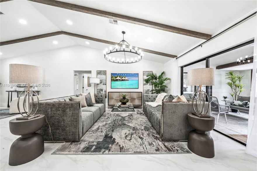 Welcome to this reimagined 4/2 pool home in the heart of Coral Springs, where modern design meets warm character. Vaulted ceilings with striking wood beams create a dramatic first impression, while new flooring, fresh interior & exterior paint and designer lighting elevate every space. The custom kitchen is a true centerpiece in this open concept home. The bathrooms have been completely renovated with bespoke vanities and upscale finishes. Step outside to your own tropical escape featuring a sparkling pool & brick pizza oven-perfect for entertaining or relaxing Florida-style. Ideally located near top rated schools, parks, shopping & dining. A rare blend of style, comfort and location- this one is unforgettable. No HOA!