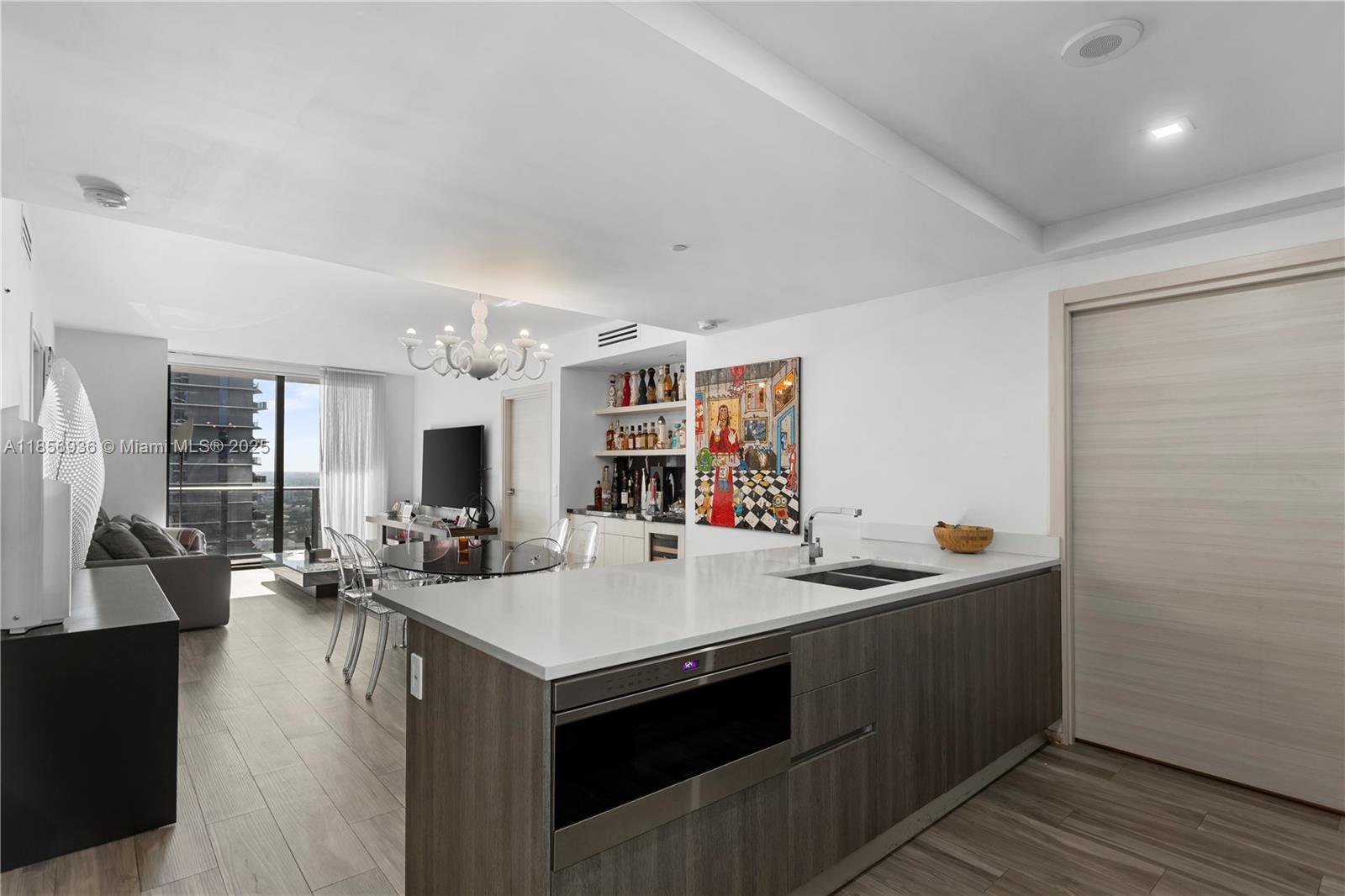 Spectacular condo at SLS LUX featuring private elevator entry, soaring ceilings, and a well-designed layout with 2 bedrooms, 2 baths, and a spacious den—perfect for a home office or media room. Enjoy an upgraded bar area with marble countertops, ideal for entertaining. The condo also includes a large laundry room and pantry. The master suite offers a built-in closet and a luxurious bathroom with a separate shower and soaking tub. Beautiful porcelain floors run throug the condo, adding warmth and style. The chef’s kitchen is outfitted with premium Wolf, Bosch, and Sub-Zero appliances and sleek Italian cabinetry. Residents enjoy exceptional services including room service, a spa, and 24-hour concierge. Located directly across the street from Brickell City Centre. AVAILABLE AUGUST 15, 2025!