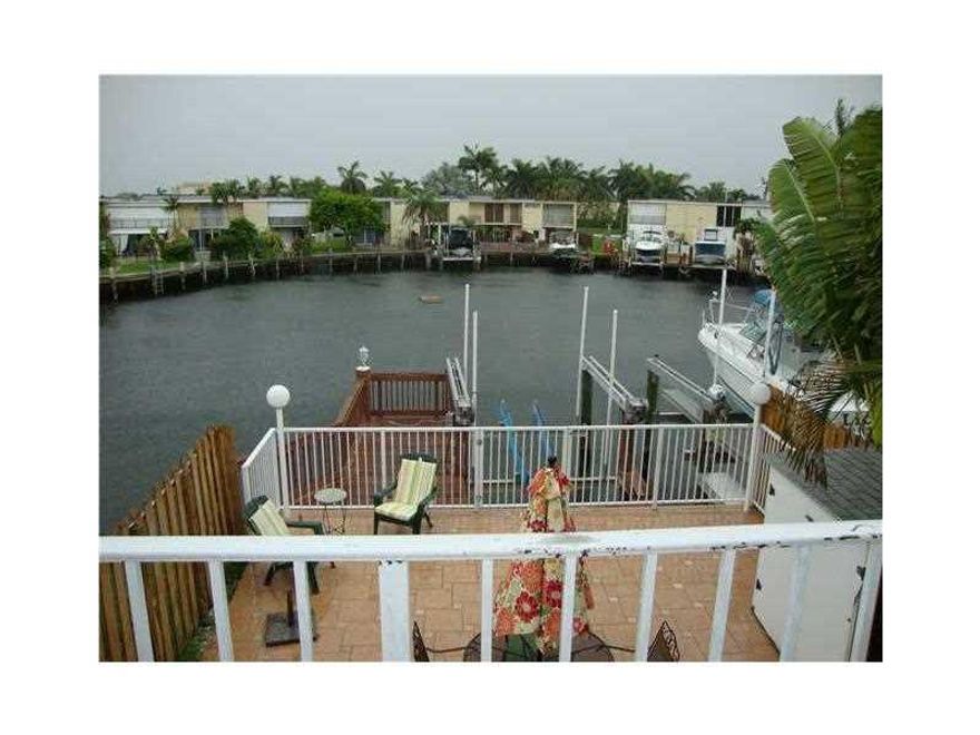 Turnkey rental.  Waterfront 3/2.5 townhome in desirable Three Islands neighborhood. All updated with marble floors, granite countertops and stainless steel appliances.  Furnished.  Private boat lift with ocean access.  Secure automatic shutters on all win dows. Guard-gated community. Great neighbors with swimming pool and tennis courts. Walk to  restaurants and beaches. Close to airports and seaports. Two to three weeks for association screening.