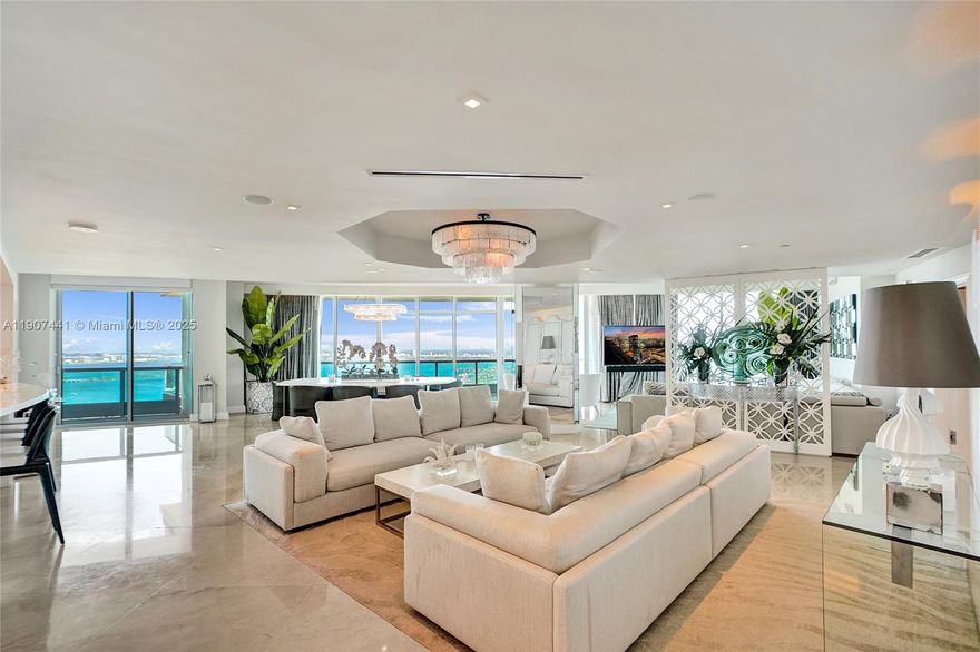 IMPECCABLY DESIGNED AMBIENT-STYLE PENTHOUSE WITH BREATHTAKING PANORAMIC BAY & OCEAN VIEWS! This gut-renovated masterpiece showcases $1.5M in upgrades and 36x36 marble floors throughout. Spanning 3,793 SF plus 991 SF of terraces, it offers 3 bedrooms with smart beds, a cinema/media room, and 3.5 baths. Elegant open living, dining, and work spaces flow seamlessly for grand entertaining. Enjoy wraparound 270° balconies, an Italian Aran Cucina eat-in kitchen, custom furnishings, and a serene primary suite with steam room and jetted tub. Full-service building by Luis Revuelta with interiors by Sam Robin, minutes from South Beach, Brickell, Wynwood & the Design District.