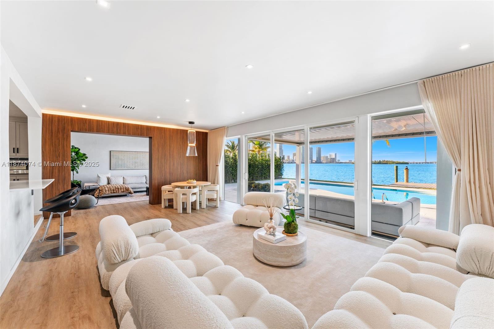 Experience refined living in this newly renovated mid-century modern masterpiece. This approx. 3,900 sq. ft. residence sits on a generous 13,500 sq. ft. lot with 90 feet of prime Biscayne Bay frontage, showcasing unobstructed views of the bay and the iconic Miami skyline. Featuring 4 spacious bedrooms and 5 bathrooms, the home is designed with both comfort and sophistication in mind. A peaceful cul-de-sac setting ensures privacy, while the covered outdoor dining area and private dock create the ultimate backdrop for entertaining or relaxing against breathtaking vistas.
Perfectly situated, this home offers a short drive to Brickell, Midtown Miami, the Design District, and the world-famous beaches of Miami Beach — placing luxury shopping, dining, and culture right at your fingertips.