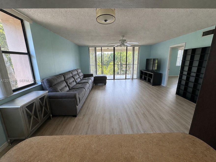 Light, bright, immaculately kept, spacious (almost 1400 square feet!) CORNER-UNIT condo in a well-maintained community with completed SIRS and Milestone inspections, plus a new roof in 2024. Ideally located near both the elevator and stairway, this home also includes a nearby, on-property, floor-to-ceiling cage--EXTRA STORAGE for items such as bicycles.

Enjoy resort-style amenities including a sparkling pool, relaxing jacuzzi, and BBQ AREA. The LARGE SCREENED BALCONY overlooking the pool offers the perfect space for morning coffee, outdoor dining, or relaxing evenings with peaceful views.

Inside, you'll find LAMINATE flooring throughout the living areas, bedrooms, and closets (2019), with tile flooring in the kitchen, hallway, and bathrooms. The spacious EAT-IN KITCHEN features updated cabinetry, generous table space, a breakfast bar opening to the living area, and a garbage disposal installed in 2020. NEWER A/C installed in 2022. All windows feature brand-new screens installed in 2025.

Additional highlights include an IN-UNIT WASHER AND DRYER, CEILING FANS in the living room and primary bedroom, and a spacious primary suite with a WALK-IN CLOSET.

Excellent WALKABLE location near Publix, Starbucks, restaurants, diner, urgent care, indoor golf, CVS, fitness center, and more. Conveniently located across Broward Blvd from the Preserve Golf Course & Club. A perfect blend of comfort, convenience, storage, amenities, and easy South Florida living.