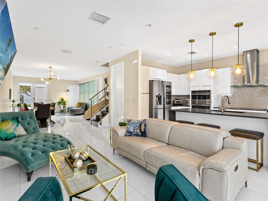 Stunning tri-level townhome in the heart of Doral, just steps from top schools, shopping, and dining! This turnkey residence features a bright, open layout filled with natural light from expansive impact windows. The entry level welcomes with generous living spaces, a versatile "enclosed den" ideal for a home office or guest retreat, a full bath and a modern open kitchen with family dining. Complete spacious laundry room and smart storage throughout, plus an enclosed 2-car garage with an electric vehicle charger and two additional exterior parking spaces for peace of mind. Upstairs, three private bedrooms provide comfort and privacy. The rooftop double terrace steals the show: it is semi-covered, fully private and equipped with a summer kitchen and built-in BBQ for unforgettable Miami nights. Additional premium upgrades—personal hot tub, cold plunge, patio furniture, infrared sauna and entertainment elements—might be included only with competitive offers. Available immediately!