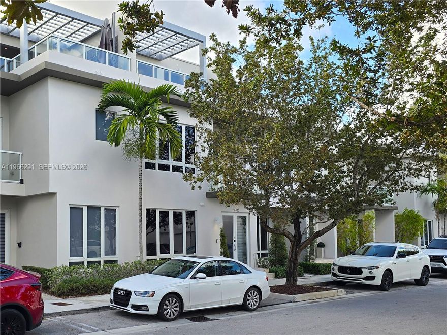 Stunning tri-level townhome ideally located in the heart of Landmark/Doral, just moments from top schools, shopping, and dining. Designed with both style and functionality in mind, this residence offers a bright, open layout enhanced by expansive impact windows that fill the home with natural light. The entry level features inviting common areas, a versatile enclosed den (perfect for a home office or guest space) and a full bathroom. Upstairs, three private bedrooms provide comfort and tranquility, while the crown jewel awaits at the top: an exceptionally private rooftop terrace complete with a summer kitchen, barbecue, bar, and bathroom—an entertainer’s dream for unforgettable gatherings under the Miami sky. Enjoy the convenience of a 2-car garage, dedicated laundry room, pantry and more. Move-in ready and available immediately. (Not included in purchase price: personal hot tub, infrared sauna, dry-clean air dresser, smart massage chair and ice-barrel cold plunge)