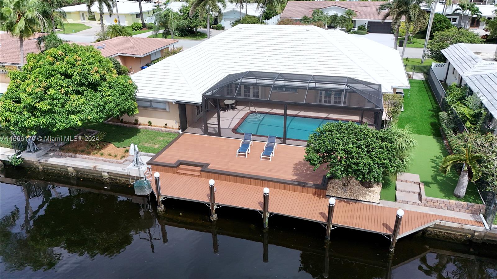 GREAT LOCATION!! Step out into your waterfront oasis located in The Landings. This beautiful 3/3 home has a brand new dock, deck, and fresh landscaping. Also features a screened-in patio with a refinished diamond bright pool. Easy access to the ocean with deep water & NO FIXED BRIDGES- perfect for large boat owners, with up to 95 feet of dock space.
The kitchen has brand new stainless steel appliances, inside has been freshly painted, original terrazzo flooring throughout, two-car garage, spacious living room and dining area. The master bedroom has his-and-her walk-in closets along with beautiful french doors that offer easy access to the heated pool. Minutes away from the beach, top-rated schools, shopping, dining, and so much more!