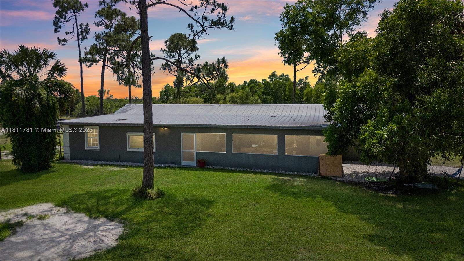 WELCOME TO A SLICE OF COUNTRY SERENITY JUST MINUTES FROM CITY CONVENIENCE! At 40691 Suzan Drive, Punta Gorda, this 5-acre AG-zoned haven offers peaceful living just north of the Lee County line and close to Cape Coral, Babcock Ranch, and Fort Myers. Inside the spacious home, you'll find 4 oversized bedrooms, 3 bathrooms, and warm laminate wood flooring throughout. Step onto the huge front porch, sip your morning coffee, or watch evening sunsets. For equestrian lovers, the property is fully outfitted with 3 stalls, tack room, wash rack, round pen, and a patience pole. Dog pens, chicken coops, and a workshop/pole barn for your tools and toys. A tranquil pond sits at the back, completing this rare blend of comfort and rural charm. Call now to experience the lifestyle you’ve been searching for