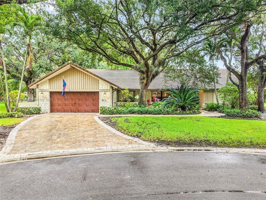 Welcome to Maplewood Isle, an exclusive 24-hour gated community of just 104 custom homes. This 4-bed, 3-bath home is tucked away on a cul-de-sac and offers luxury, comfort, and functionality. Inside, enjoy vaulted ceilings, a triple split-bedroom layout, a spacious master suite with a sitting area, a granite and stainless steel kitchen, tile and wood laminate floors, a fireplace, and a built-in entertainment center. The screened patio features a pool and room to entertain. The garage is remodeled into a recreational room with a pool table, seating area, and a big screen TV. Home includes impact windows and doors.