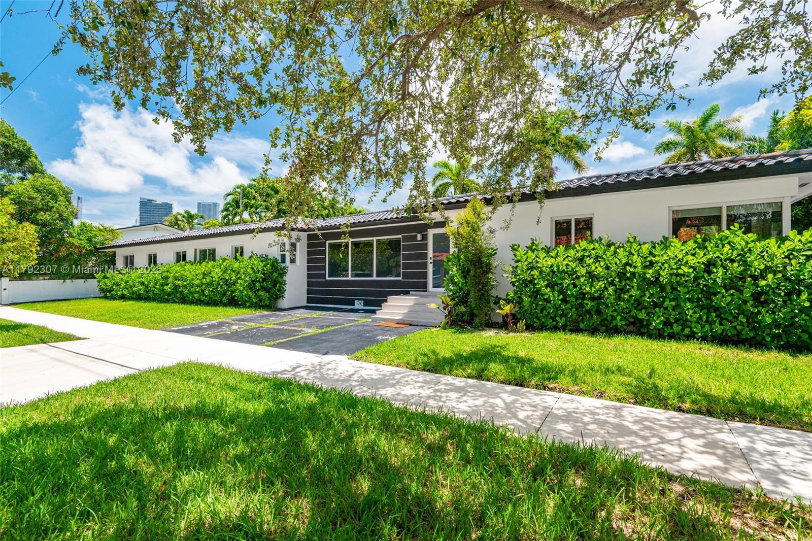 This spacious property offers a total of 6 bedrooms and 4 bathrooms, including a 4-bed / 3 bath main home and a separate 2-bed/1 bath apartment with a private entrance perfect for legal rental income, guest accommodations, or multigenerational living. You can live in one and rent the other, or seamlessly combine both into one expensive residence. The home has been fully remodeled with permits, featuring 2,600 SQ FT of interior space designed for comfort and functionality. Ideally located just 10 minutes from the beach and Miami International Airport, and within proximity to Downtown Miami, Wynwood, and the Design District. Enjoy a private outdoor area ideal for entertaining and experiencing the full lifestyle in one incredible property.