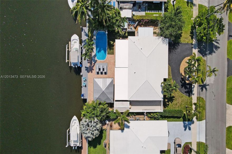 The Ultimate Boater's Oasis in Garden Isles–Waterfront Luxury Re-imagined. Rare double-wide canal making navigation a breeze. Enjoy direct ocean access just minutes from the open ocean and unique gated parking area for RV or other toys. RARE 75 ft water frontage and upgraded boat lift. Only 2 fixed bridges w/ high clearance on a quiet, no-thru traffic street perfect for children, grandchildren & dog walking, this remodeled  3-bed 2-bath Smart Home offers the perfect blend of tropical relaxation and high-tech convenience (Smart features include Voice-operated or by cell phone> door locks, ceiling fans, lighting, appliances & thermostat. Entertainer's dream w/ outdoor tiki bar w/ metal roof and professional-grade outdoor kitchen w/ running water. Whether you’re hosting a summer BBQ or practicing your short game on the custom putting green surrounding the pool, the outdoor lifestyle here is unmatched. After sunset, unwind in the 5-person hot tub or find peace in the lush reading garden filled with blooming roses. Features a rare 32x12 ft gated side area perfect for boat trailer, RV, golf cart fleet, or additional car storage, 14x8 ft shed for your tools and addt'l storage, composite dock decking, updated flooring and bathrooms.
Manatee, tarpon, blue crab and many saltwater fish live in the canal. Sit back and fish or watch ocean life visit your dock daily. More than a home; it’s the waterfront lifestyle you’ve been waiting for. See Supplemental Remarks for further details.