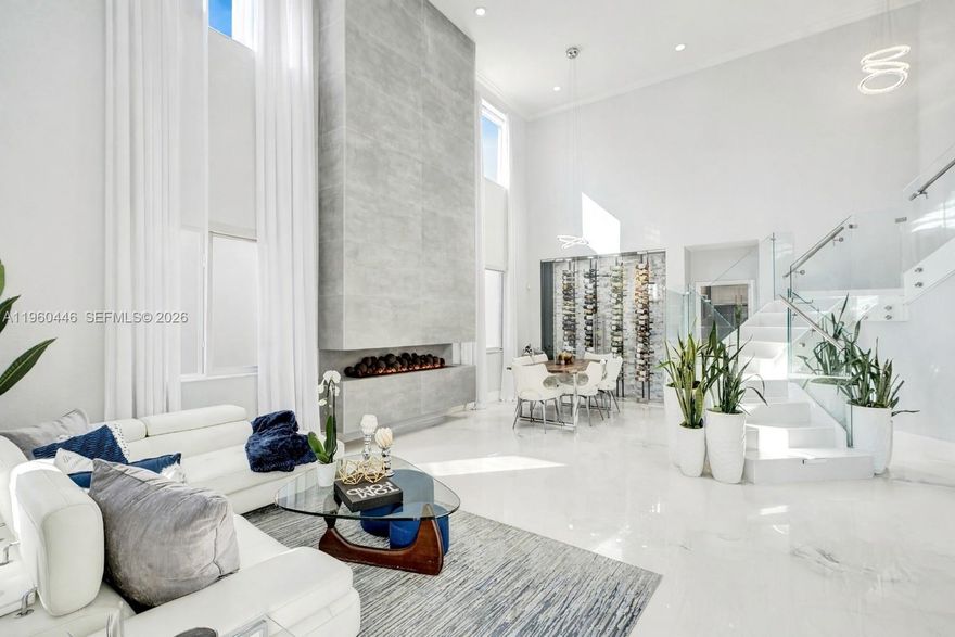 Stunning Fully Remodeled Estate Home in Coconut Cay! Welcome to this beautifully updated two-story residence offering approximately 3,400+ sq. ft. of living space, designed for comfort, style, and functionality. Built in 2006, this home has been fully remodeled and showcases modern finishes throughout to include high impact doors and windows.

The spacious layout features generously sized bedrooms w/ a featured bedroom on the first floor & bathroom, walk-in closets, and floor-to-ceiling design elements that elevate the home’s transitional appeal. The main living area is anchored by a striking floor-to-ceiling water vapor fireplace, creating a dramatic yet inviting focal point. A built-in wine rack feature wall adds sophistication and is perfect for entertaining.

Enjoy peace of mind with a new HVAC system and a home water filtration system. The luxurious spa-inspired primary bathroom offers a serene retreat, while additional bathrooms are tastefully updated and well appointed. Additional highlights include a 3-car garage, ample storage, and thoughtful details throughout.

The exterior is enhanced with accent stonework and architectural soffit lighting, delivering impressive curb appeal day and night. Ideally located in Miami Gardens, this home offers convenient access to major highways, shopping, dining, schools, and entertainment.

Designer furnishings are negotiable. This is a rare opportunity to own a turn-key home with space, upgrades, and style.