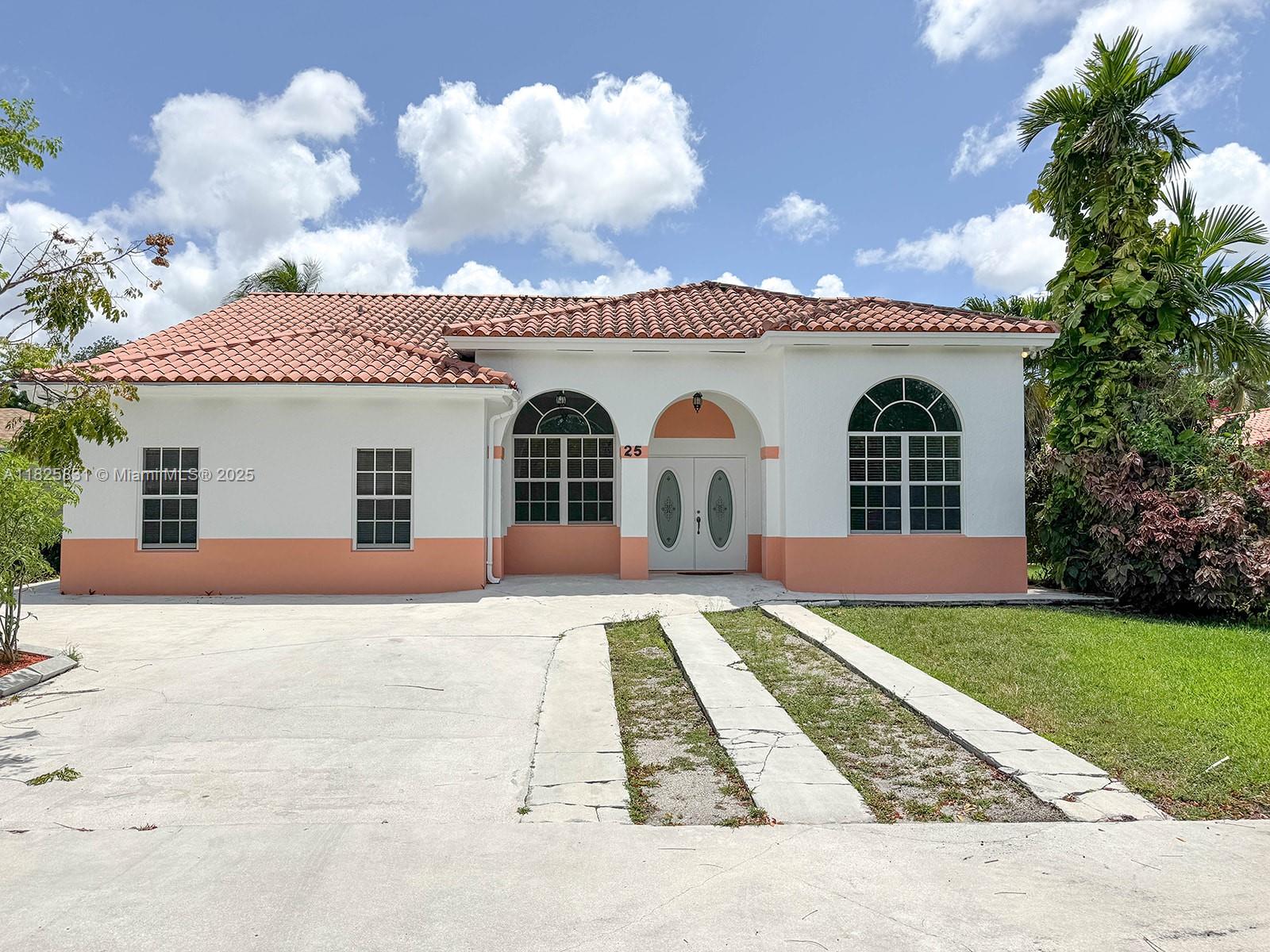 Original owners of 2400sq' one of a kind 2002 custom built and elevated home in Miami Springs. Home is a 4 bedroom 3.5 baths, and includes two master suites. Open Concept with vaulted ceilings, modern kitchen with externally vented range hood. Home has large windows and spectacular tray ceilings providing natural light throughout. Alarm system, new whole-house smoke detectors and in-floor combination safe. Lighted large attic loft storage area. Home is completely wheelchair accessible and designed. This is your opportunity to make it your own. This home is ready for your personal touch. Red tile Roof, new A/C (2024) and modern Washer/Dryer units. Interior and exterior has recently been painted. French doors open to large rear concrete deck with alley access, large storage shed.