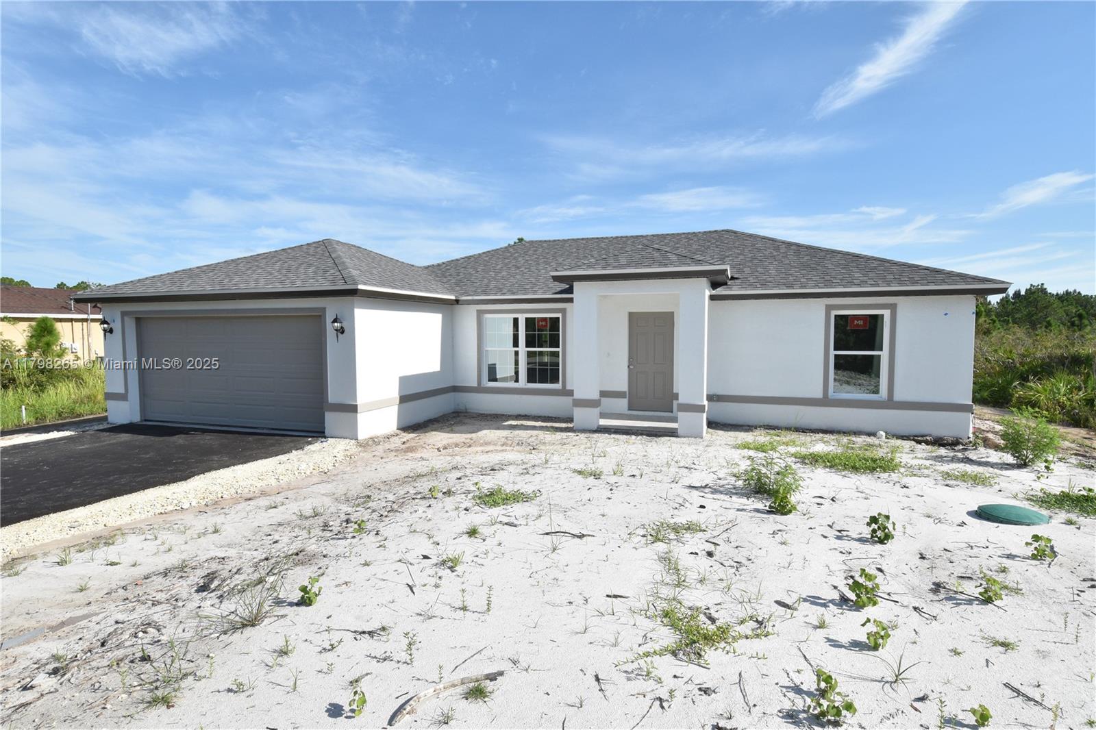 New construction Home located in the northern area of Golden Gate Estates. This cozy 3 Bedroom Two bathroom is built on a 2.27 acres lot, plenty of space to move around! Features a two car garage, split bedroom design, combination tub and shower and wall tile at bathrooms. Lanai enclosed with screen. Paved, public access road. Close to the Seminole casino hotel; Collier county fair grounds; Big Corkscrew island regional park and soon to be available retail and commercial at Winchester Center. This home is still under final construction stage with an estimated time to complete of a month.