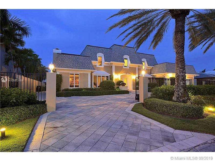 Classic luxury home in the prestigious island community of SUNRISE KEY consisting of 75 waterfront homes w/ police patrol and one gated entrance.  100 feet of waterfront, ocean access with on fixed bridges.  Up-dated throughout w/ exquisite custom finishes & mill work.  Gourmet gas kitchen, unique outdoor covered veranda w/ full stainless steel summer kitchen equipped with pizza oven.  Marble & hardwood floors throughout, sauna, 6 beds/5 baths, gas generator, central vac.  Close proximity to downtown Ft. Lauderdale, the airport, fine shops and dining. Conveniently located within minutes of Whole Foods and Fresh Market.