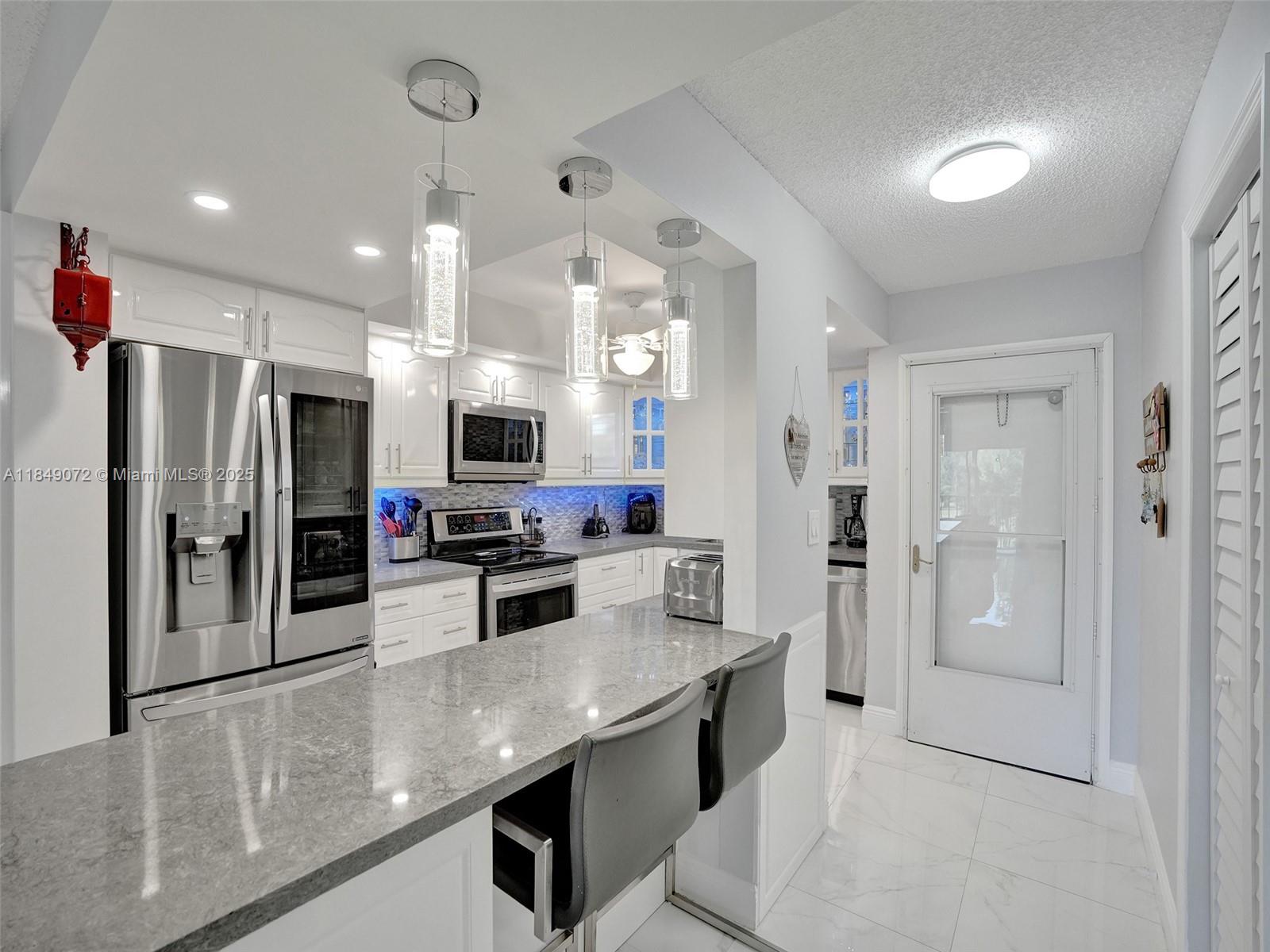 This beautifully renovated 2-bedroom unit is fully furnished and ready for immediate move-in, offering peaceful golf course views from the screened balcony. The sleek kitchen includes new stainless steel appliances, and ceramic tile flows throughout the entire space. A washer and dryer are located inside the unit for added convenience. Situated in a gated HOPA community with completed 40-year inspection, residents can enjoy amenities such as a heated pool, fitness center, clubhouse, tennis and pickleball courts, and a billiards room. Ideally located near shopping and restaurants, this unit is easy to show.