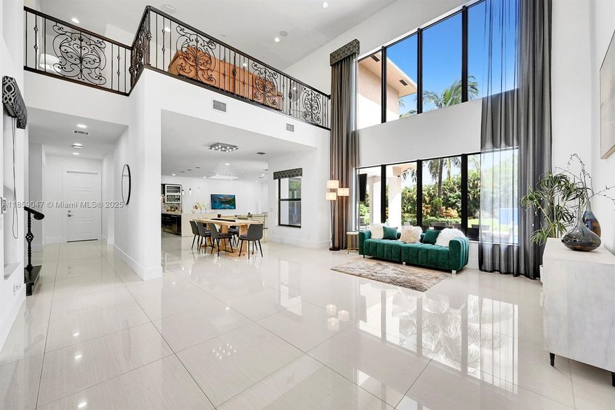 Stately, refined and spectacular. A wonderful turnkey estate in the best part of Plantation Acres, on a quiet cul-de-sac literally minutes from American Heritage, Posnack, Mizrahi, K12 Prep, Plantation Prep, Archbishop McCarthy, The Plantation Equestrian Center, Volunteer Park & Sawgrass Mills. Spanning more than 1 lush acre and sporting a sprawling pool deck, fantastic covered patio & summer kitchen, this villa features an ample 5 beds and 5 baths plus an office/media room, 3-car garage, a dramatic foyer with 25' ceilings, a Thermador-equipped chef's kitchen, an oversized island perfect for dining & entertaining and a massive first-floor primary suite that segues seamlessly to the pool deck, delivering quintessential indoor/outdoor flow. This estate is offered fully furnished, call today