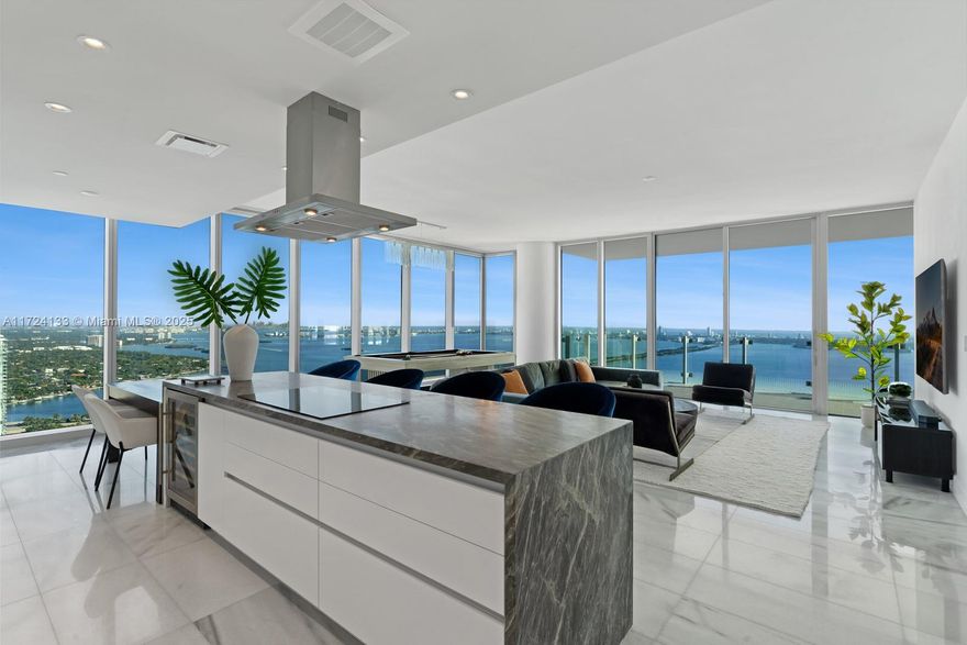 Indulge in unrivaled luxury at Missoni Baia, an architectural masterpiece with 200 feet of Biscayne Bay frontage. Residence #5401 is a 3-bedroom, 4.5-bath corner unit with staff quarters, offering 2,552 sqft of exquisite living space, with all en-suite bedrooms and custom closets. Floor-to-ceiling windows showcase breathtaking northeast Bay and ocean views, while marble floors enhance the living areas. The chef’s kitchen boasts stunning Blue de Savoie marble counters and WOLF/Sub-Zero appliances. The primary suite offers a spa-inspired bath and custom closet. Residents enjoy world-class amenities, including an Olympic lap pool, fitness center, wellness spa, tennis court, valet, concierge, and 24/7 security. Ideally located near the Design District, South Beach, Downtown, and Brickell.