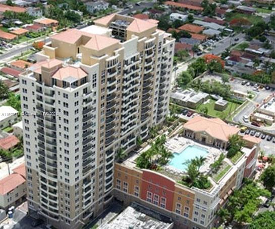 THIS UNIT IS PRICED TO SELL!!! OWNER IS MOTIVATED...Fabulous location close to everything. Leave your car behind. This building sits right across great retail and grocery with everything you need. This is a full service residence with 24 hour concierge and security. Huge pool, exercise room, club room ,covered parking, Much sought after corner unit. 5 short blocks to Miracle Mile which offers great dining and retail. 10 minute drive to Airport. This unit offers spacious living with beautiful Tile floors and updated kitchen, air conditioning and bathrooms.
