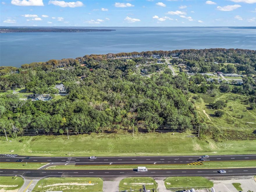 Excellent opportunity to acquire 8.35± acres in a rapidly growing corridor of Leesburg, Central Florida, adjacent to a lake and located at the southern edge of The Villages area. This highly desirable location benefits from continued expansion, strong buyer demand, and long-term growth drivers. The property features public water and sewer on site, significantly reducing development time and infrastructure costs. Positioned along S 14th Street, the site is well suited for residential or mixed-use development, making it an attractive opportunity for builders and developers targeting one of Central Florida’s most active markets. Proximity to major roadways, employment centers, retail, and The Villages® lifestyle amenities further enhances the site’s appeal and marketability.