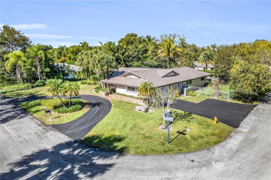 Discover your dream family home in the heart of Palmetto Bay, the coveted "Village of Parks" known for its lush greenery, top rated schools and serene suburban charm.  This spacious 4-bedroom, 2-bath single family residence sits on a desirable corner lot, offering extra privacy, ample yard space and excellent curb appeal.  The split bedroom pan provides added privacy perfect for families or guests. Step inside through impact-resistant front doors for added security and peace of mind, while accordion shutters protect all the other windows and doors-perfect for Florida's weather. The inviting living areas flow seamlessly to a screened-in pool, ideal for year-round outdoor entertaining and relaxation with family and friends. Recent updates include a fairly new flat tile roof and pre-wiring for a portable generator, ensuring comfort and preparedness. The kitchen features KitchenAid appliances approximately 3 years old making meal prep a joy. Conveniently located just blocks from scenic Old Cutler Road-a historic, tree-canopied gem perfect for biking, walking, and enjoying Palmetto Bay's Natural beauty with easy access to beautiful Biscayne Bay. Great investment opportunity! Don't miss this Palmetto Bay home in one of Miami's premier family-friendly communities!