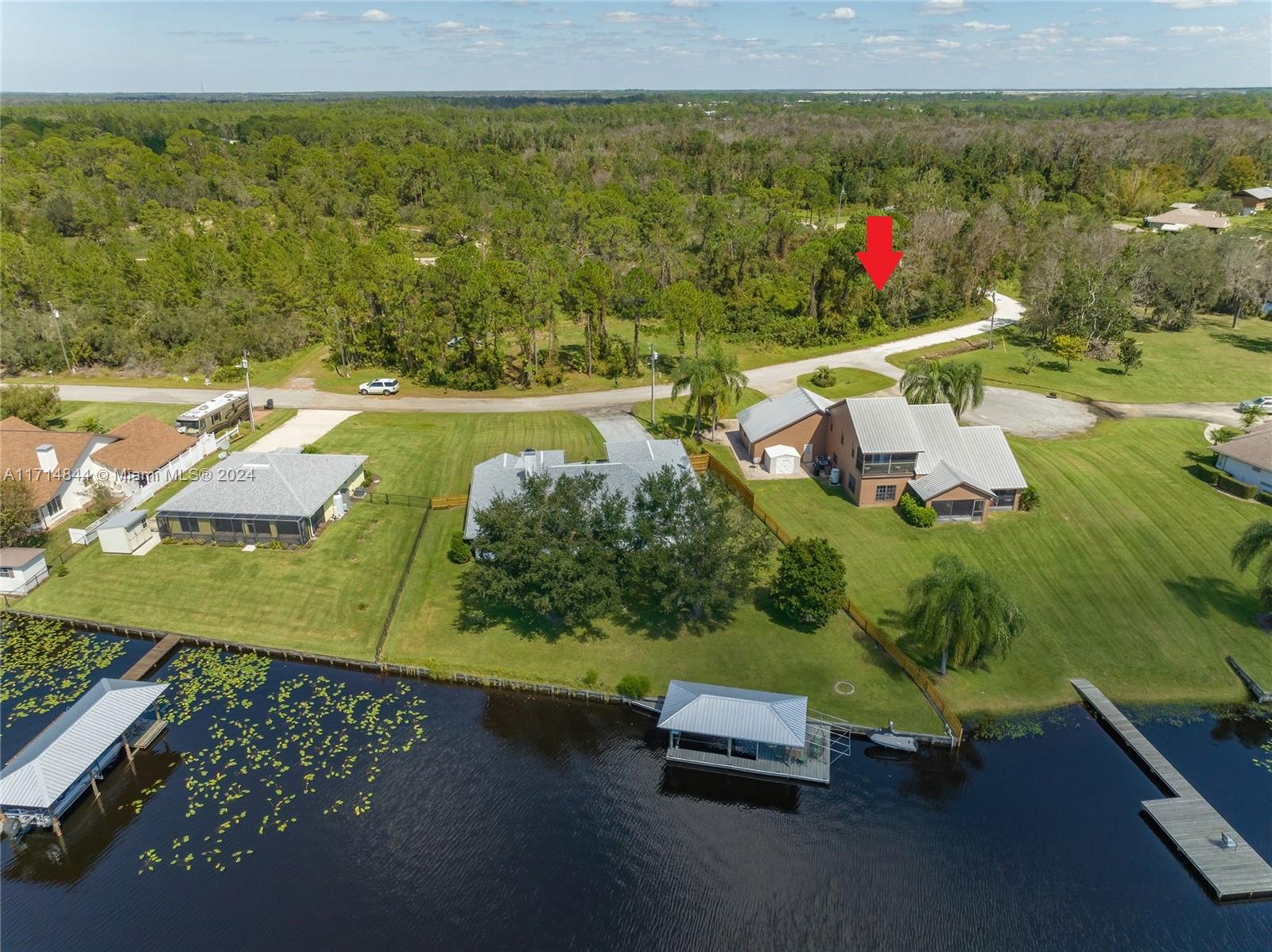 Seller financing available. This huge corner lot 18,731 Sq.ft / 0.43 acre, with a beautiful lake view is located in a peaceful, & remote wooded area, where you may see a deer and exotic birds; a golf cart or a quad will take into the pathways inside the wilderness. This lot is directly across million dollar homes on lake Carrie in Lake Placid, a town in Highlands County, known as the "Caladium Capital of the World" and the "Town of Murals," featuring 47 murals throughout the area. This small town is recognized for its caladium farms & lots of lakes; the center of this village is very active, with luxurious stores and a fresh market every Saturday. Famous Sebring International race is just 20 minutes away. Golf courses are close by; bring your jet skis and boats to the ramp of lake Carrie.