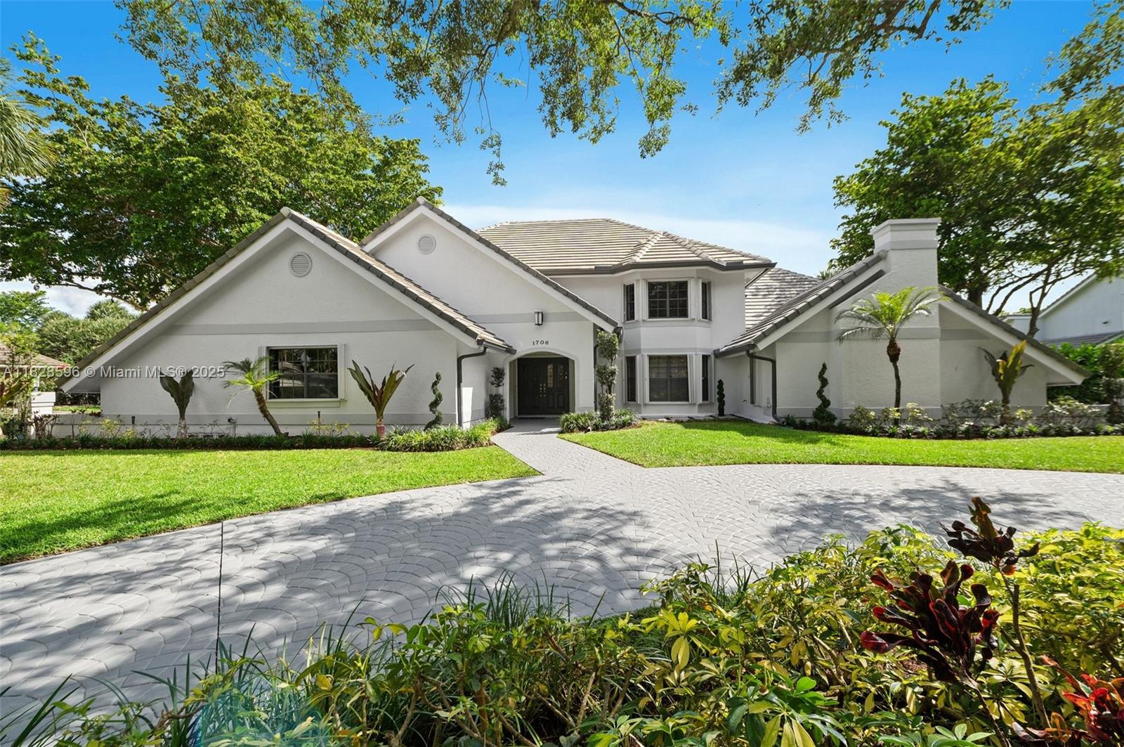 This spacious and bright 5 BD/5 BA move-in ready corner lot home with soaring ceilings is located in Maplewood Isle, one of the most charming gated-communities in SoFlo. Kitchen features quartz counter tops, induction cook top & SS appliances. Primary BD on first floor, has dual walk-in closets & additional sitting area overlooking the pool. Primary BA has stand-alone bathtub, shower & two vanities. Three other BD have walk-in closets. All bathrooms renovated. The home also features a loft & wet bar on 2nd floor. Fenced-backyard & screened-in heated pool on travertine patio. Lots of storage, new roof installed in 2021 & the whole house was re-piped in 2023. Connections set for a built-in outdoor kitchen. Three car-garage & two driveways to fit 10 cars. Light fixture in loft doesn't convey.