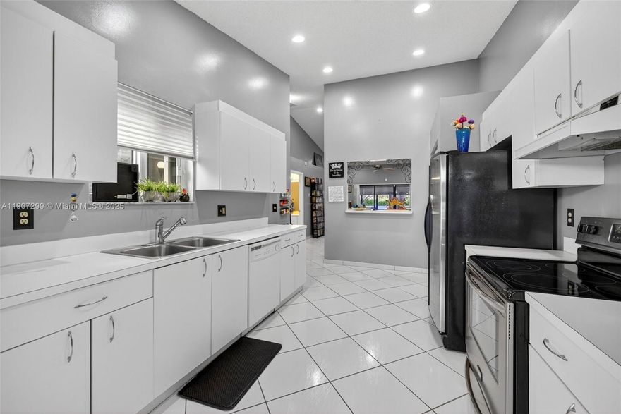 Beautifully updated 2-bed, 2-bath villa in Spring Valley Villas featuring vaulted ceilings, oversized tile in the main living areas, wood flooring in bedrooms, and a light-filled eat-in kitchen with 42” cabinets, newer appliances, and garbage disposal. Spacious primary suite offers two walk-in closets. Major upgrades include a 2023 roof, hurricane-impact windows plus shutters, tankless water heater, and renovated bathrooms. Enjoy a screened patio, 1-car garage, and community pool. Convenient location near the Tamarac Sports Complex, shopping, dining, and main roadways. Move-in ready with modern finishes throughout. Very easy to show.