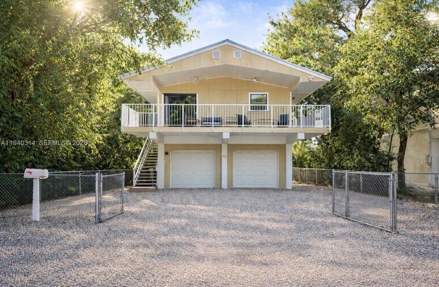 Paradise starts here, in the heart of Key Largo. Tucked among mature trees, this corner stilt home in the sought-after Bay Haven community offers privacy, flexible living, and access to boating, beaches, and world-class fishing—just steps from the homeowners park. Centrally located near restaurants, shopping, and John Pennekamp Coral Reef State Park, this home captures the Florida Keys lifestyle.

The main upstairs residence features 2 bedrooms and 2 bathrooms, while the separate downstairs cottage offers 1 bedroom and 1 bathroom. A front balcony provides the perfect spot for morning coffee, birdlife views, or evening cocktails.

The property offers ample parking for vehicles and recreational toys, along with a 1-car garage and a downstairs utility room with washer and dryer. A spacious backyard and side-yard space on both sides provide excellent outdoor use and storage options.

Bay Haven homeowners enjoy a private gated park with a boat ramp and sandy beach. Access is through the Gateway to the Seas HOA. 2026 dues are $550, including one parking permit and key fob access.

The property operates under a special vacation rental license permitting rentals of less than 28 days and is advertised through Airbnb. Buyers should independently verify all licensing, zoning, and permitted uses through Monroe County. The home has been well maintained and is a must-see.