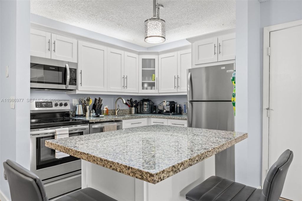 Photo of 10709 W Clairmont Cir #111, Tamarac, FL 33321 (MLS # A11986977)